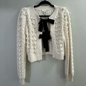 a loves a White Knit Sweater with Black Bows